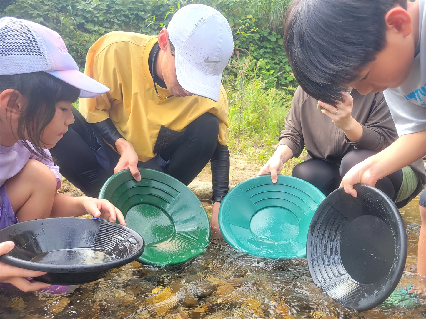 愛知県設楽町の川でパンニング皿を使って砂金を探すご家族